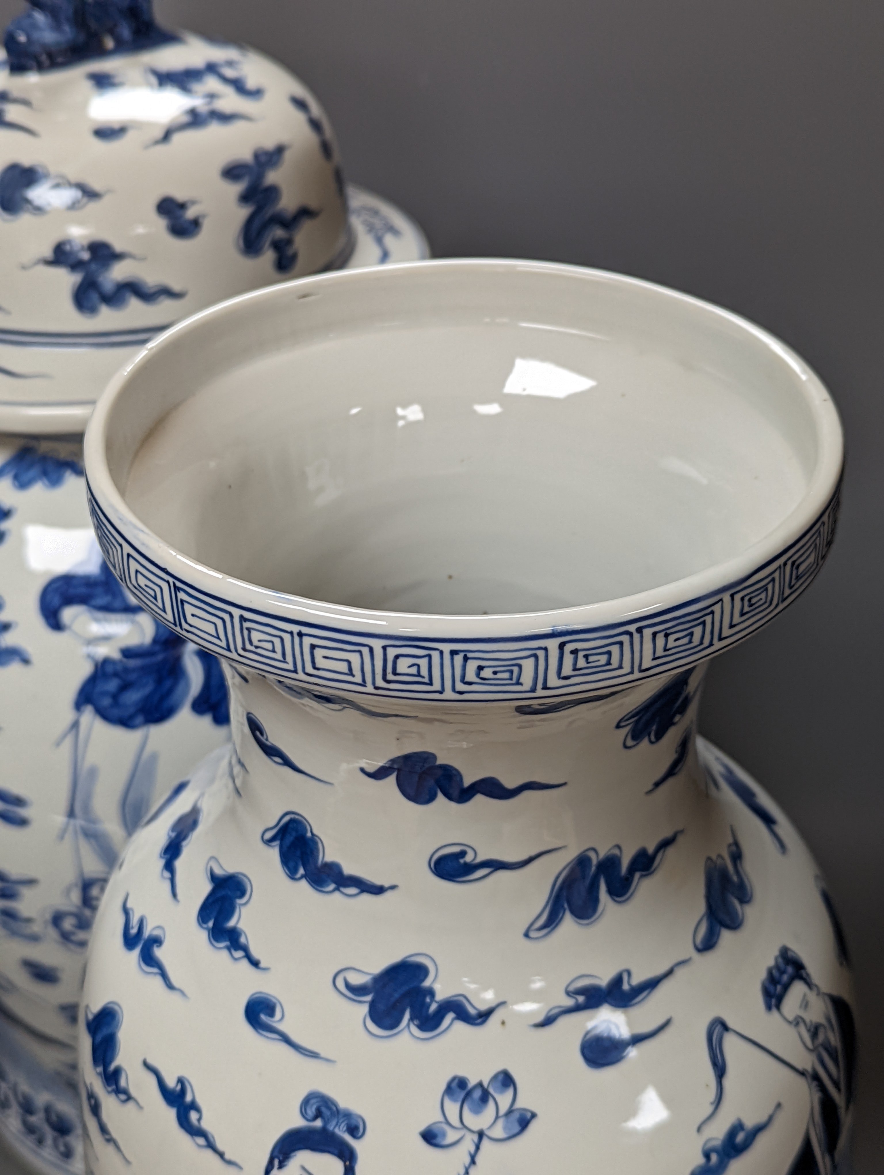 A large Chinese blue and white baluster jar and cover and matching vase, tallest 55 cms high.